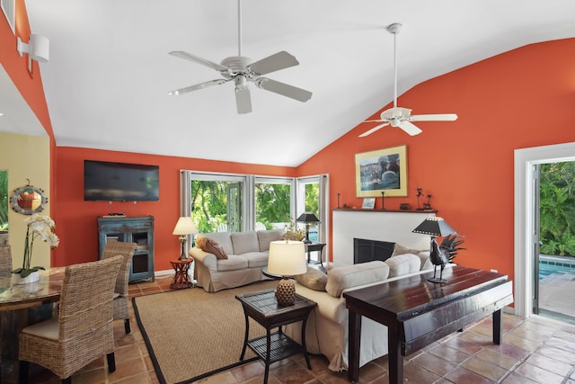 living room featuring high vaulted ceiling, a fireplace, and tile patterned flooring