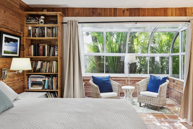 bedroom with a sunroom and wooden walls