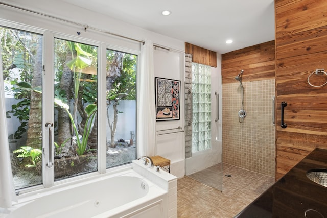 bathroom with recessed lighting, a garden tub, wooden walls, and walk in shower