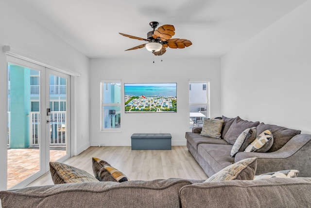 living room with ceiling fan and light hardwood / wood-style floors