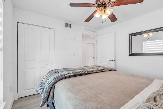 bedroom with a closet, ceiling fan, and light wood-type flooring