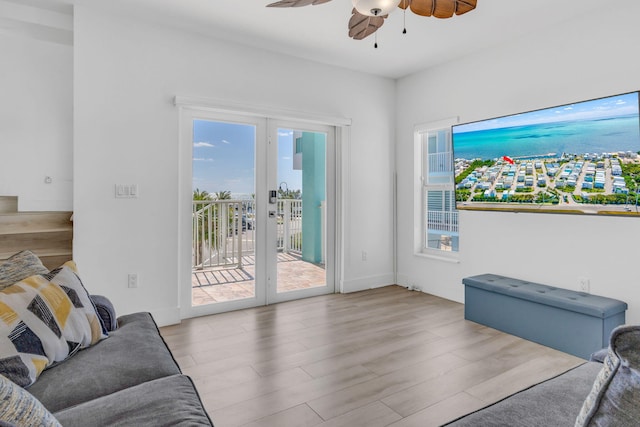 living room featuring french doors, ceiling fan, plenty of natural light, and light hardwood / wood-style flooring