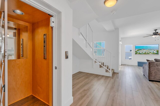 interior space with light hardwood / wood-style floors and elevator