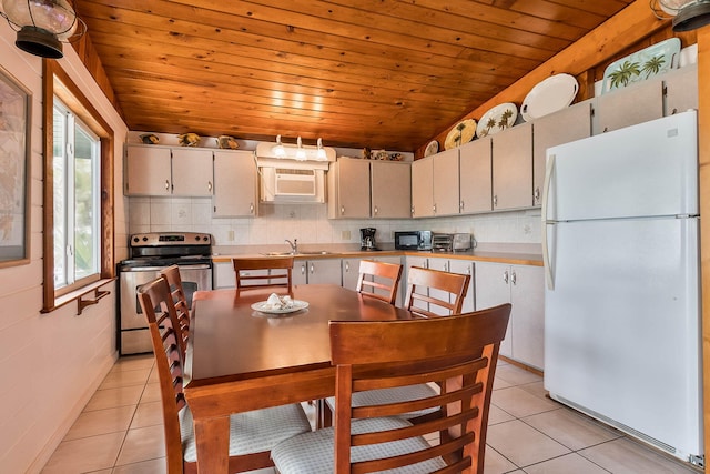 794 Narragansett Ln, Key Largo, FL 33037 - kitchen featuring freestanding refrigerator, stainless steel electric stove, light tile patterned flooring, backsplash, and wood ceiling