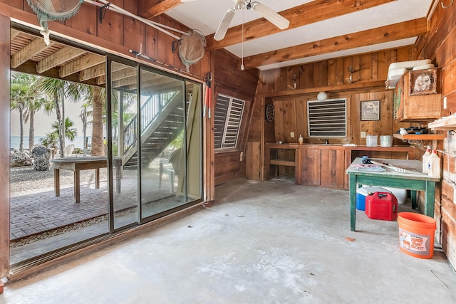 794 Narragansett Ln, Key Largo, FL 33037 - misc room featuring wood walls, unfinished concrete floors, a ceiling fan, a workshop area, and beam ceiling