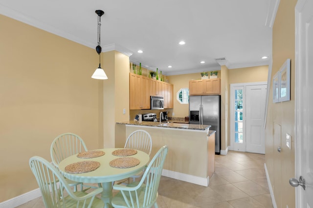 kitchen with appliances with stainless steel finishes, light stone counters, light brown cabinetry, decorative light fixtures, and kitchen peninsula