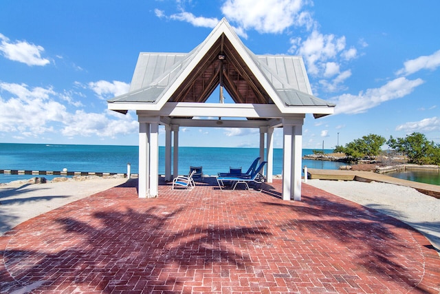 view of patio / terrace featuring a water view and a gazebo