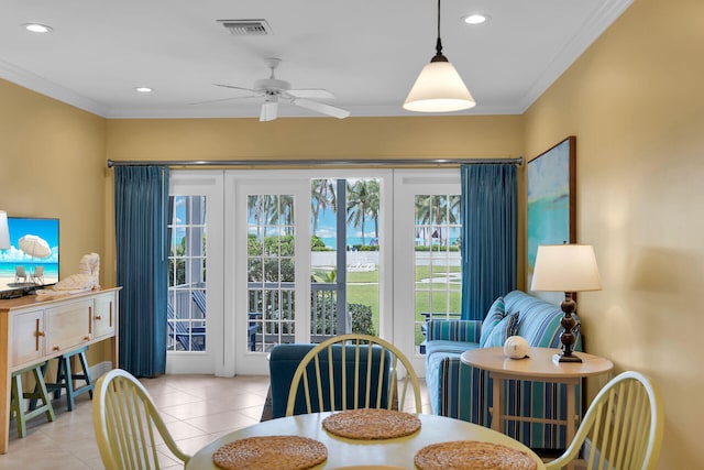 dining space with light tile patterned flooring, ceiling fan, and crown molding