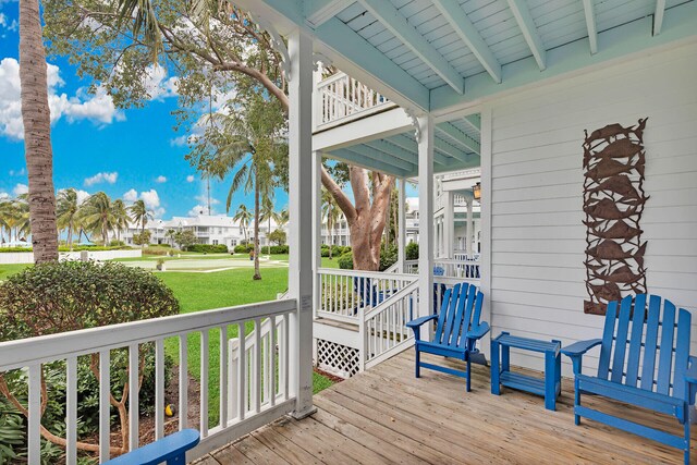 wooden terrace featuring a yard