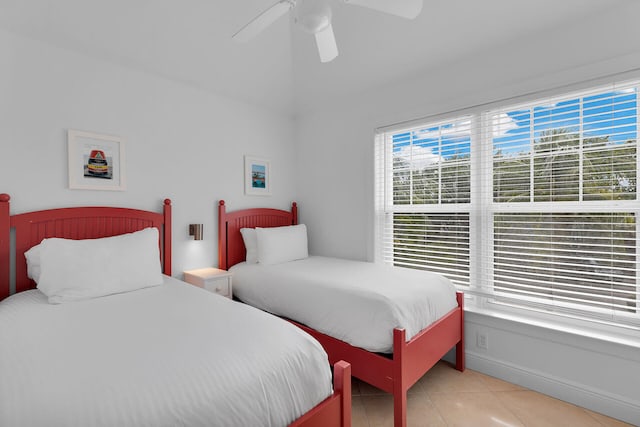 tiled bedroom featuring ceiling fan