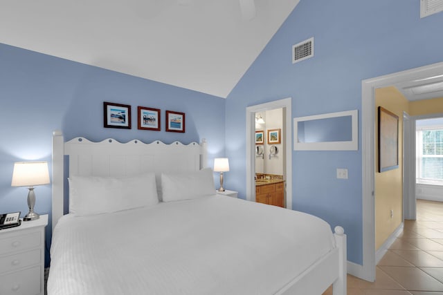 bedroom featuring light tile patterned floors, ensuite bath, and high vaulted ceiling