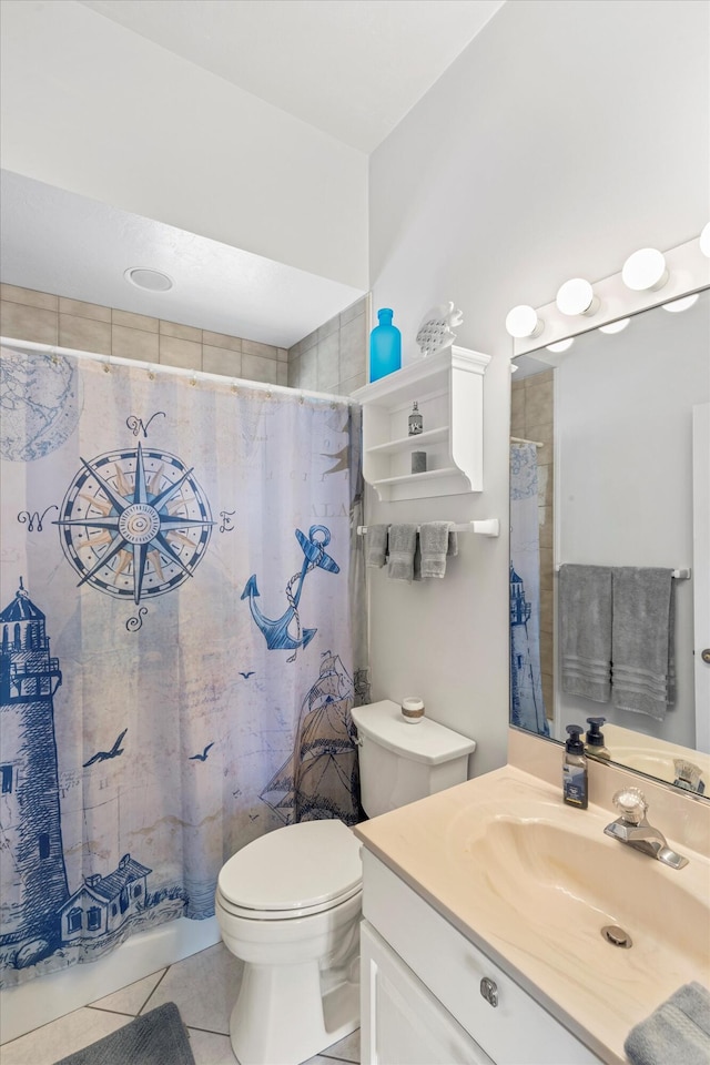 bathroom featuring tile patterned floors, toilet, a shower with shower curtain, and vanity