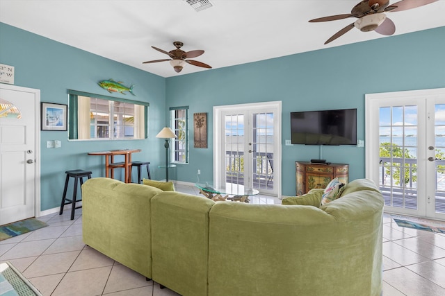 living room with light tile patterned floors, french doors, and ceiling fan