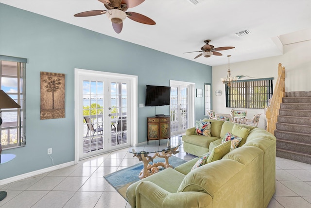 tiled living room with ceiling fan and french doors