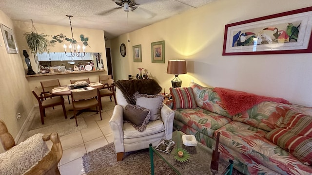 tiled living room featuring ceiling fan with notable chandelier and a textured ceiling