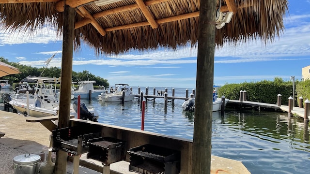 dock area featuring exterior bar and a water view