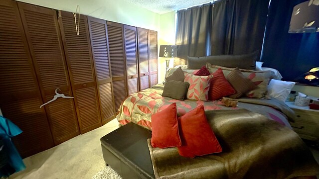 carpeted bedroom with a textured ceiling