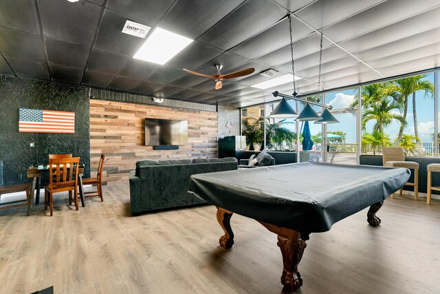 game room featuring ceiling fan, a wall of windows, hardwood / wood-style floors, and billiards