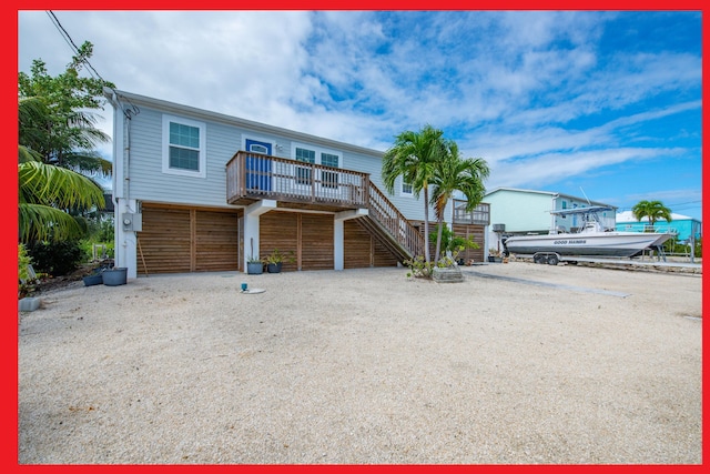 view of front facade featuring a garage and a deck