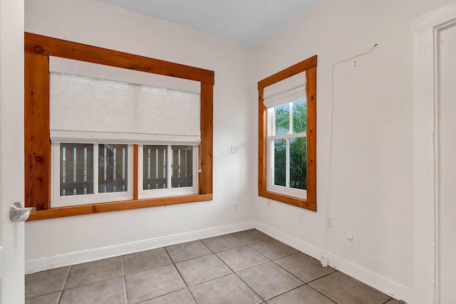 tiled empty room with baseboards