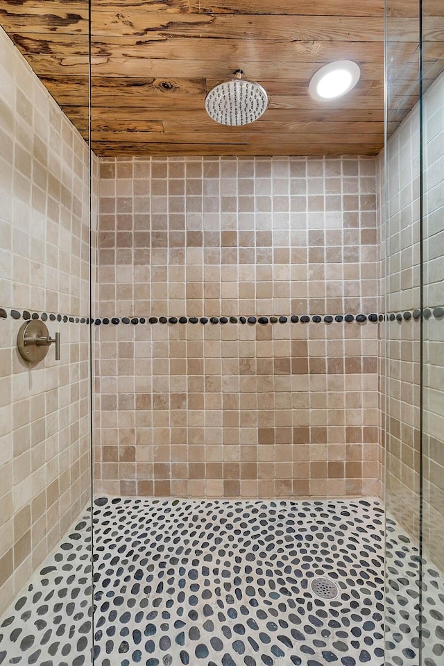 full bath featuring wood ceiling and tiled shower