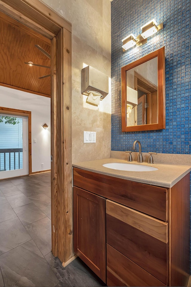 bathroom with wooden ceiling, vanity, and baseboards