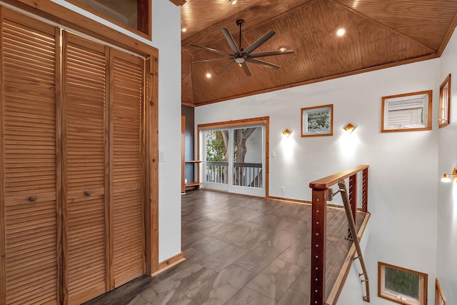 hallway with wooden ceiling, crown molding, baseboards, and high vaulted ceiling