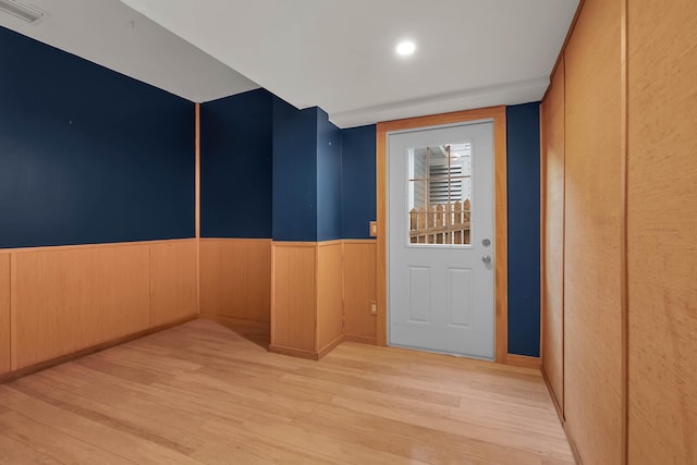 interior space with visible vents, wood finished floors, and wainscoting