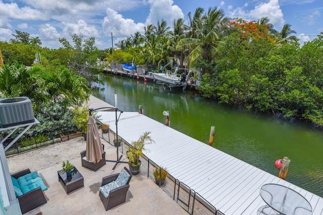 dock area with a water view, outdoor lounge area, and central AC