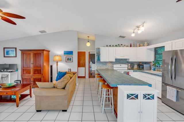 kitchen with a breakfast bar, decorative light fixtures, white cabinetry, lofted ceiling, and stainless steel appliances