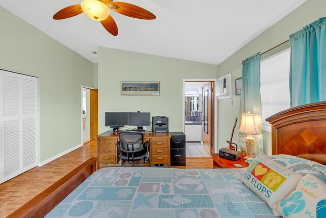 bedroom featuring hardwood / wood-style flooring, vaulted ceiling, ensuite bathroom, and ceiling fan