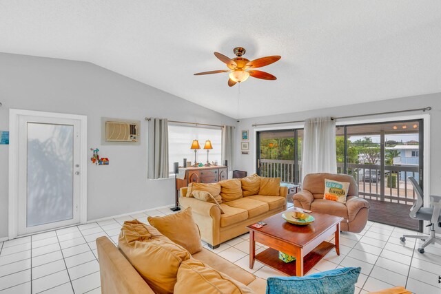 tiled living room featuring ceiling fan, a wall mounted air conditioner, vaulted ceiling, and a textured ceiling