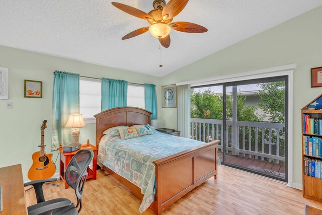 bedroom with multiple windows, access to exterior, vaulted ceiling, and light wood-type flooring