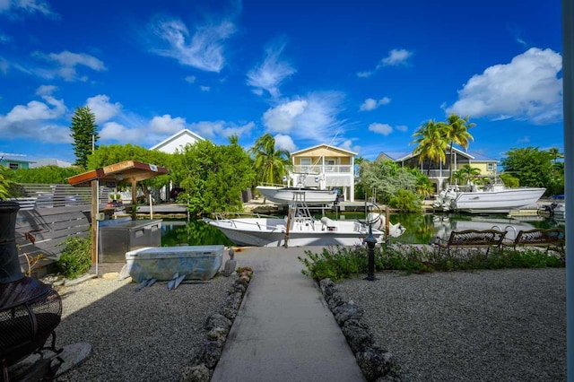 view of yard with a dock and a water view