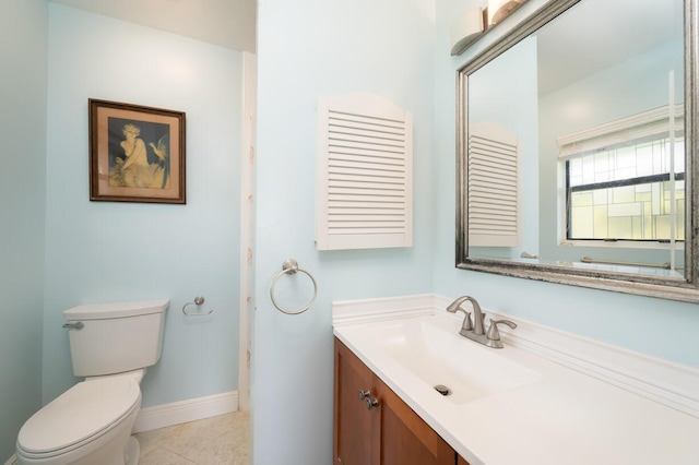 bathroom with vanity, tile patterned floors, and toilet