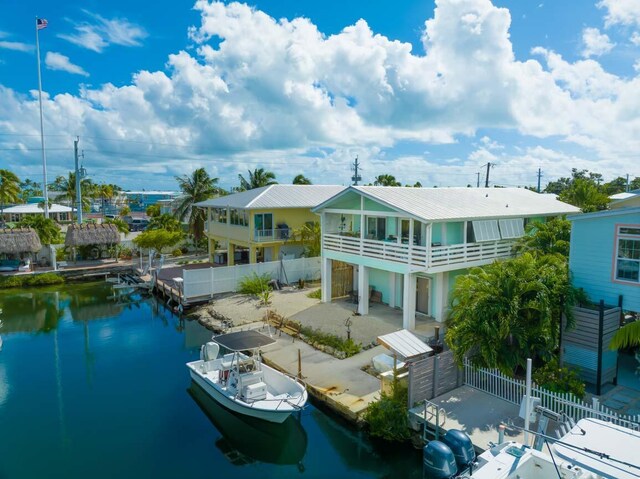 back of house with a balcony and a water view