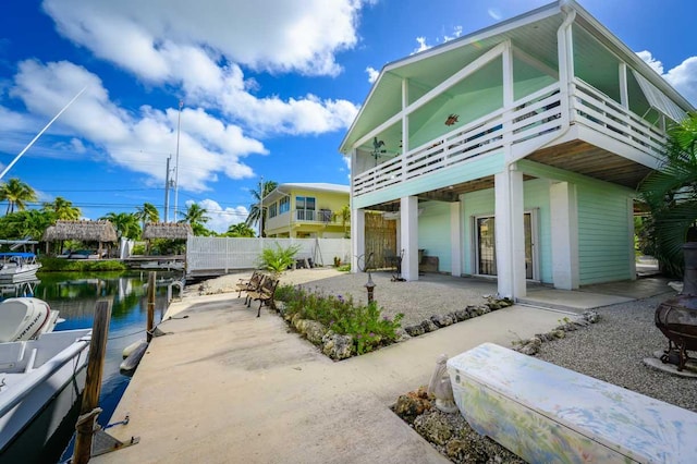 back of house with a patio area and a water view