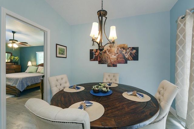 dining room featuring ceiling fan with notable chandelier and wood-type flooring