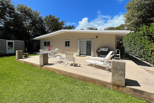 back of property featuring a lawn and a patio area