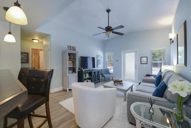 living room featuring vaulted ceiling, ceiling fan, and light hardwood / wood-style floors