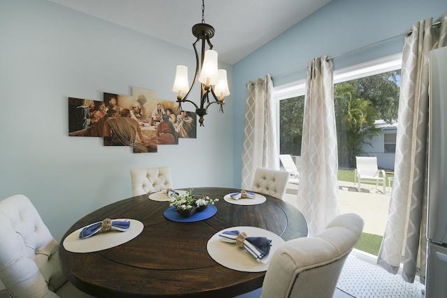 dining area featuring vaulted ceiling and an inviting chandelier