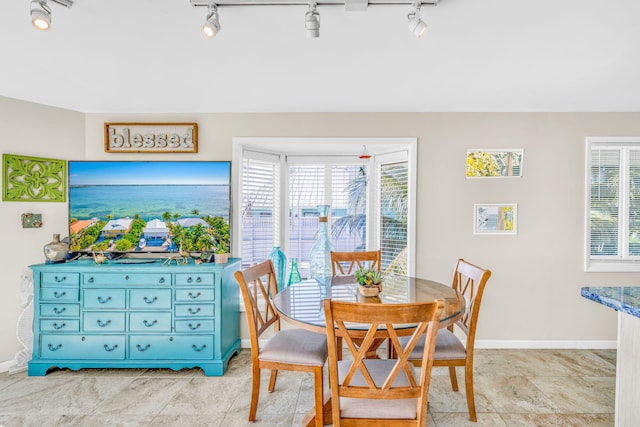 dining space featuring baseboards and a healthy amount of sunlight