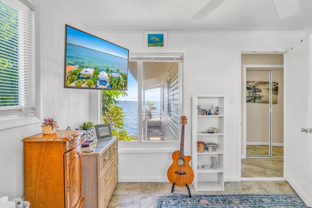 interior space with a wealth of natural light and a ceiling fan