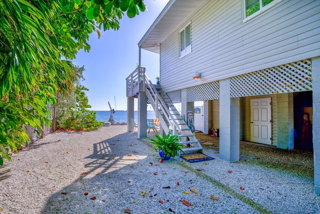 exterior space featuring a water view and stairs