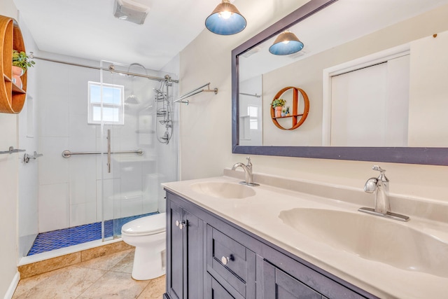 bathroom with a shower stall, toilet, double vanity, and a sink