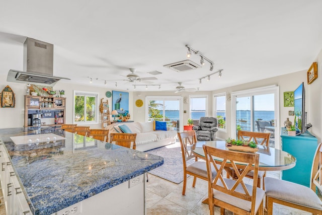 dining space featuring light tile patterned floors, visible vents, and ceiling fan