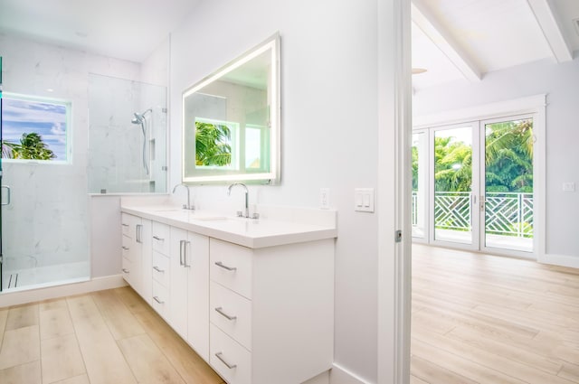 bathroom with vanity, an enclosed shower, wood-type flooring, and beamed ceiling