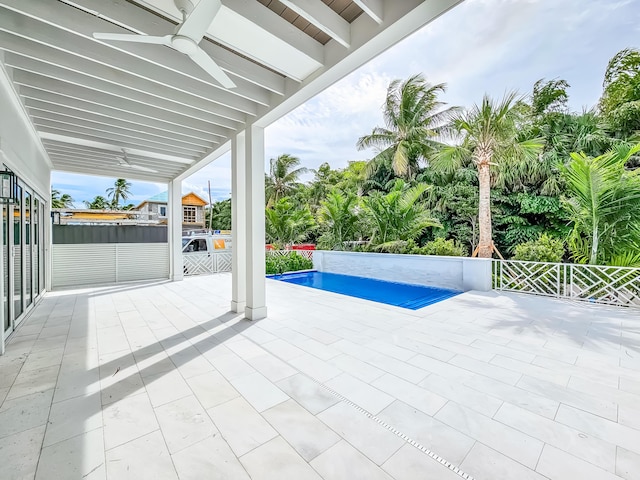 view of swimming pool with ceiling fan, a jacuzzi, and a patio area