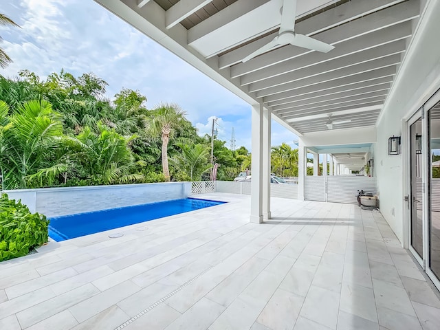 view of swimming pool with a patio and ceiling fan