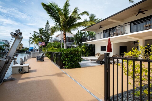 view of home's community with a water view and a patio area